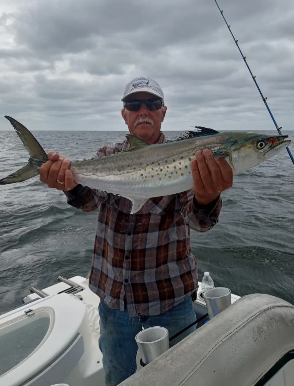 Original photo of an angler holding his catch